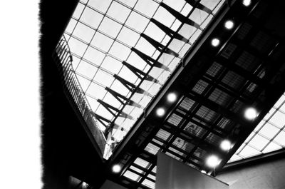 Low angle view of illuminated skylight in building