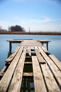 Pier over lake against sky