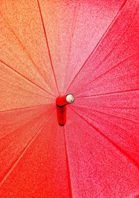 Low angle view of red umbrella on ceiling