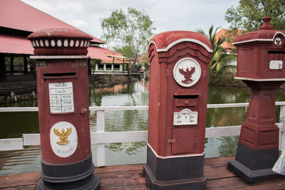 Telephone booth by building against trees