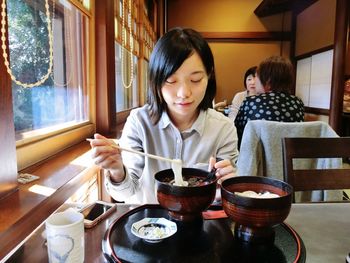 Young woman sitting in restaurant