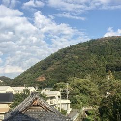 Houses on mountain against sky