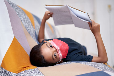 Portrait of teenage girl on book