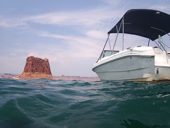 View of rock formation in sea against sky