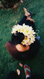 High angle view of woman holding flowers