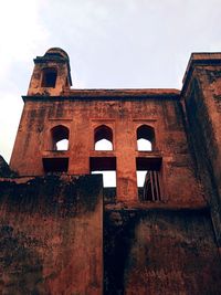 Low angle view of old building against sky