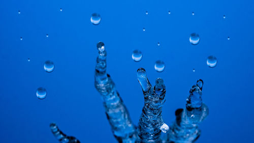 Close-up of bubbles against blue sea