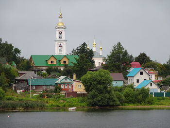 View of buildings and trees against sky