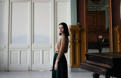 Young woman and piano in art deco interior