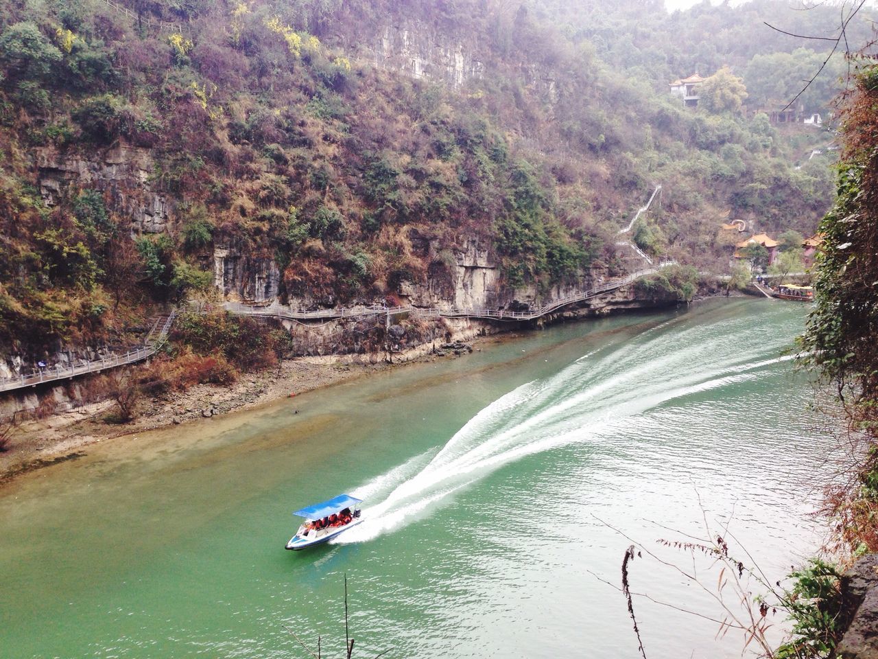 water, nautical vessel, transportation, boat, mode of transport, tree, waterfront, river, high angle view, nature, tranquil scene, scenics, tranquility, beauty in nature, mountain, sailing, travel, lake, day, vacations