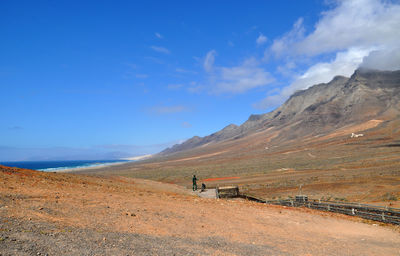 Scenic view of mountains against blue sky