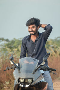 Portrait of young man riding motorcycle