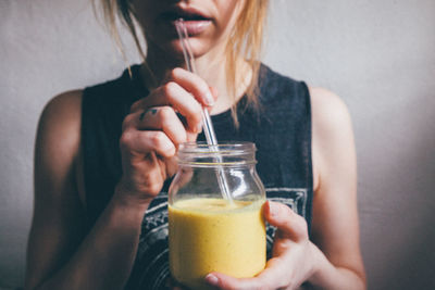 Midsection of woman holding drink