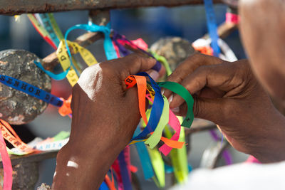  a catholic is seen tying remembrance ribbons during mass on the last friday of 2024 
