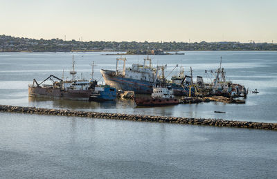 Boats in sea against clear sky