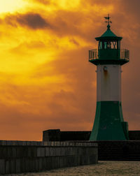 Lighthouse by sea against sky during sunset in sassnitz 