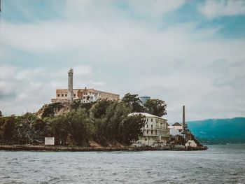 Building by sea against sky