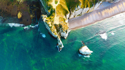 High angle view of rocks next to sea