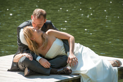 Couple sitting on a lake