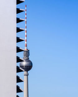 Low angle view of communications tower against sky