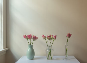 Close-up of pink flower vase on table at home