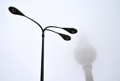 Low angle view of communications tower against clear sky