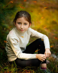 Portrait of a girl sitting on field