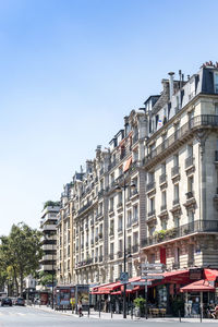 Street by building against clear sky