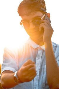 Portrait of young man holding eyeglasses