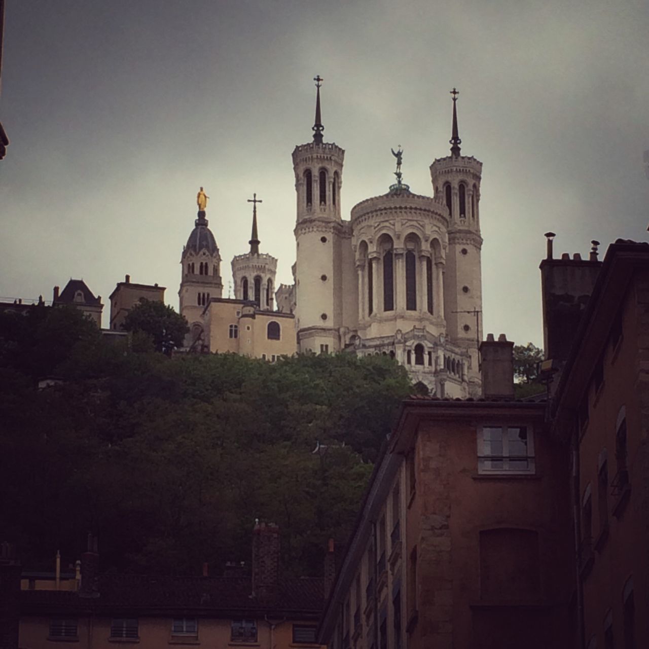 architecture, building exterior, built structure, place of worship, church, religion, spirituality, sky, low angle view, dome, cathedral, tree, cross, outdoors, history, no people, cloud - sky, day