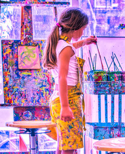 Side view of girl painting in art studio