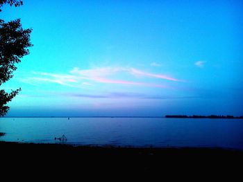 Scenic view of calm sea at sunset