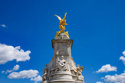 Low angle view of statue against blue sky