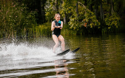 Full length of boy running in lake