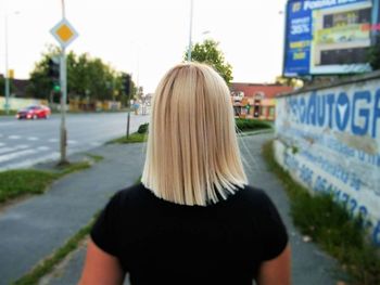 Rear view of man standing on road