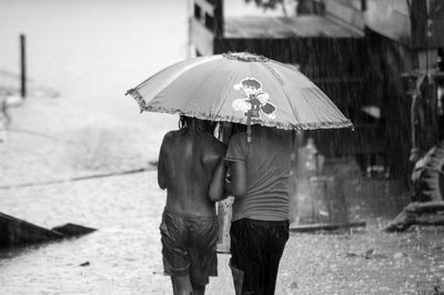 Man with umbrella standing in rain