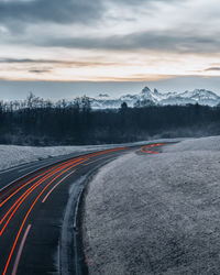 Empty road against sky during sunset