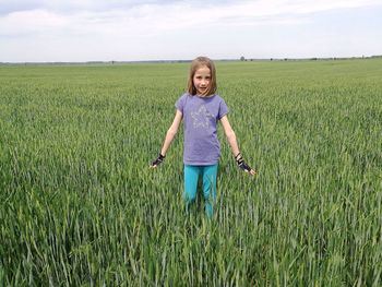 Full length of a girl standing on field