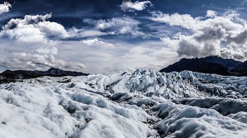 Scenic view of snow covered mountains against sky