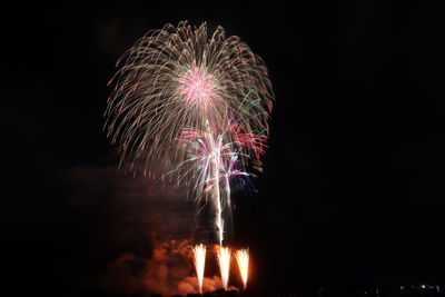 Low angle view of firework display at night