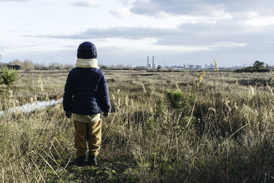 Rear view of man standing on field