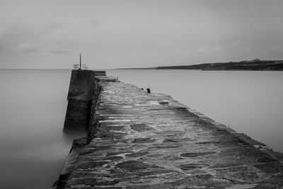 Pier over sea against sky