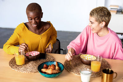 Lesbian couple having breakfast at home