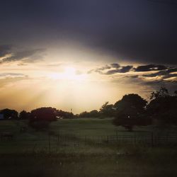 Scenic view of landscape against dramatic sky