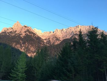 Scenic view of mountains against blue sky
