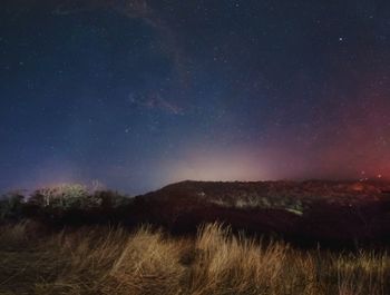 Scenic view of field against sky at night