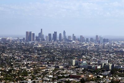 Aerial view of modern buildings in city against sky