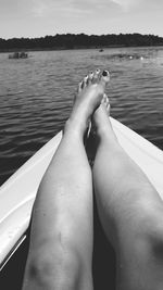 Low section of woman relaxing in lake