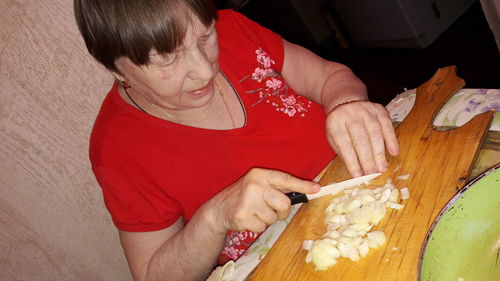 High angle view of man preparing food on table at home