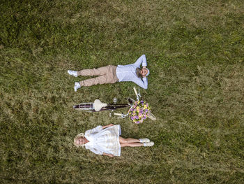 High angle view of people lying on field